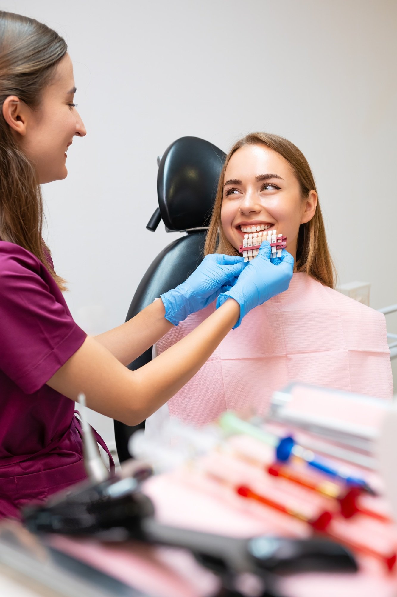 The dentist chooses the ideal shades of white to enhance the patients smile